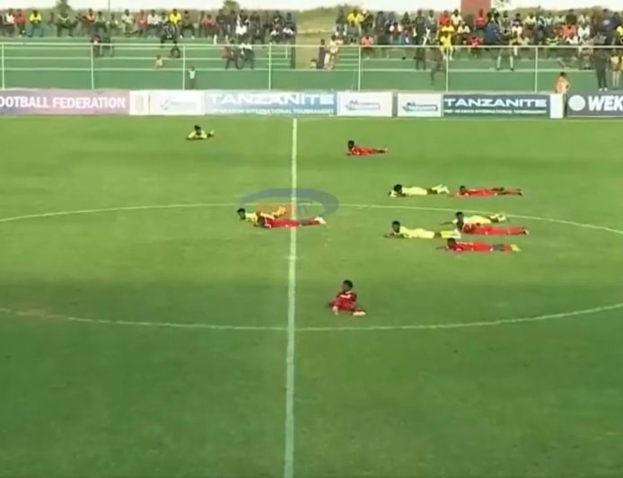 Football match stopped for bizarre reason as players and fans lie down on ground
