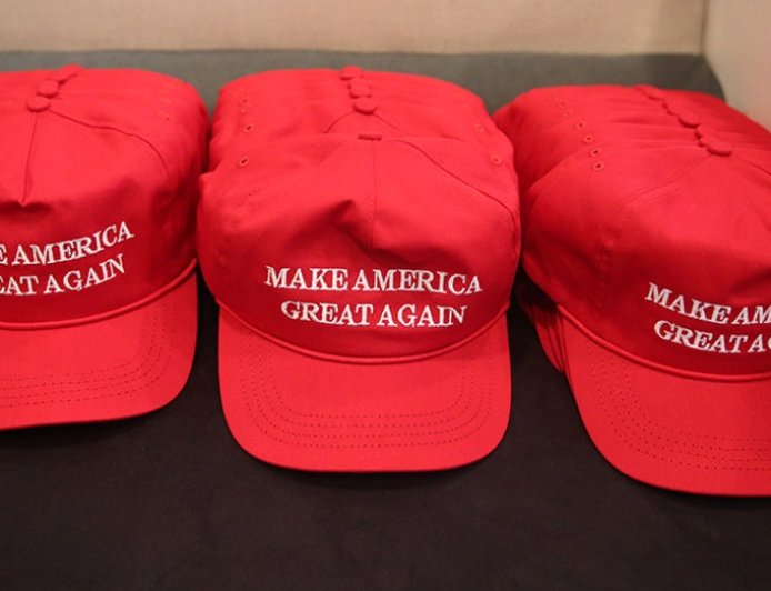 Houston Halloween display shows mannequins in red hats hanging from gallows with Mexican flag