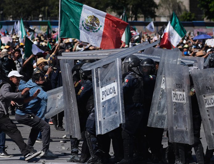 More than 100 officers injured as protesters attack police, breach barrier at Mexico's National Palace