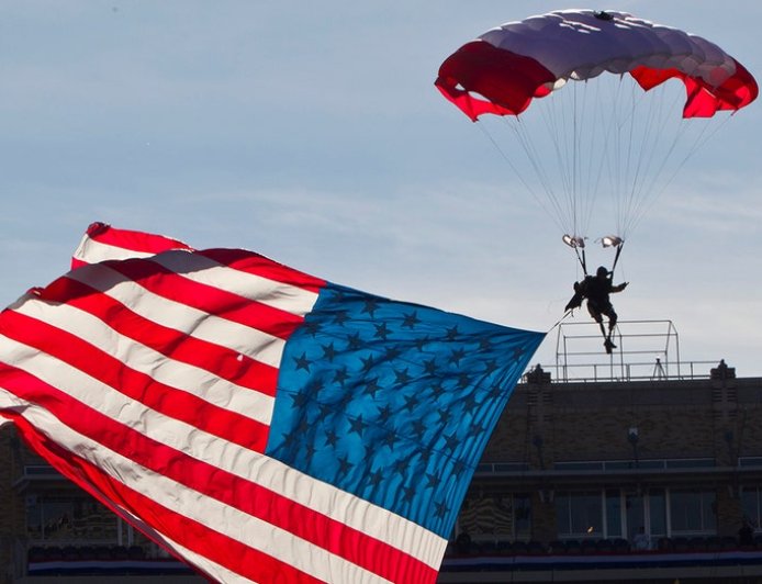 Parachutist briefly hangs above end zone during Armed Forces Bowl pregame mishap