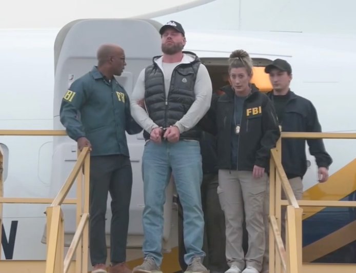 Ex-Olympian Ryan Wedding arrives in US, escorted off plane in cuffs by FBI after Mexico capture