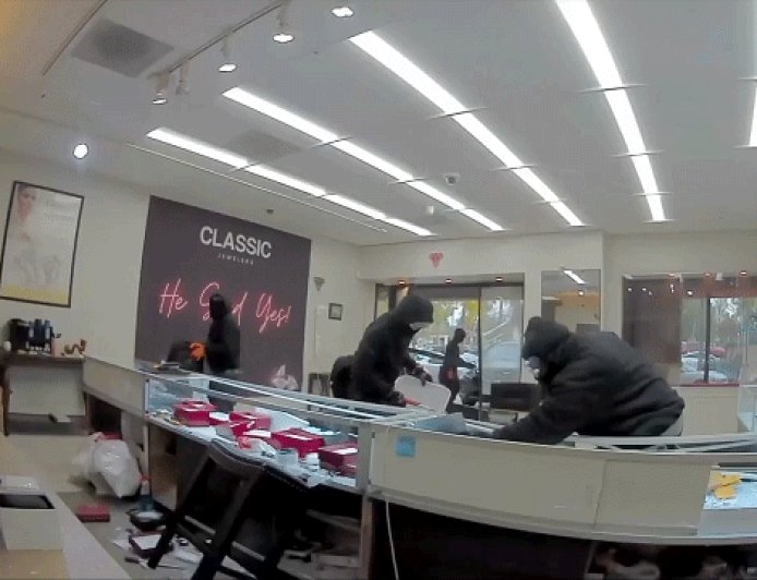 Video shows masked robbers crash car through jewelry store entrance, steal owner's gun in brazen heist