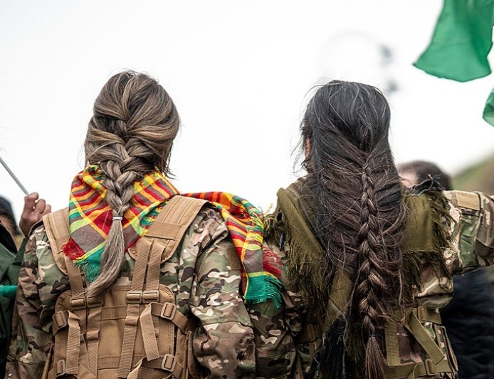 Syrian militiaman shows off what he claims to be severed Kurdish fighter's braid as Damascus asserts control