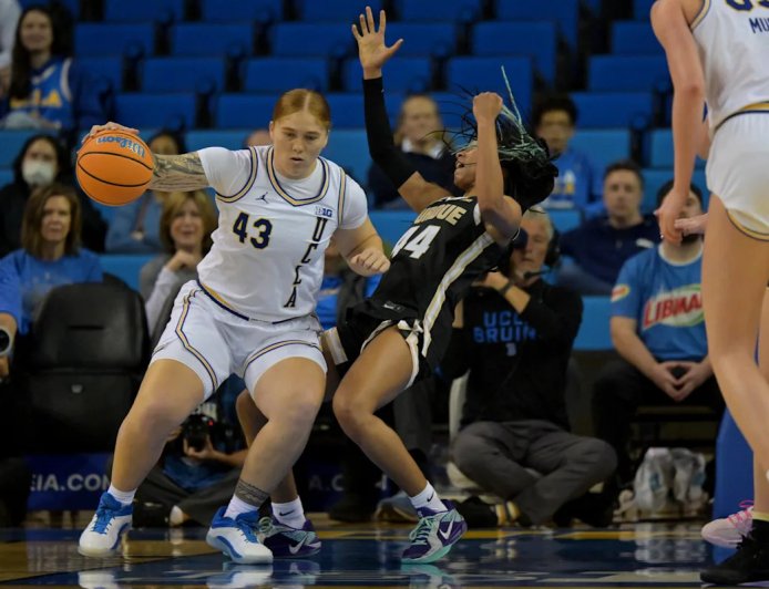 UCLA's two-sport star Megan Grant celebrates the Bruins national title